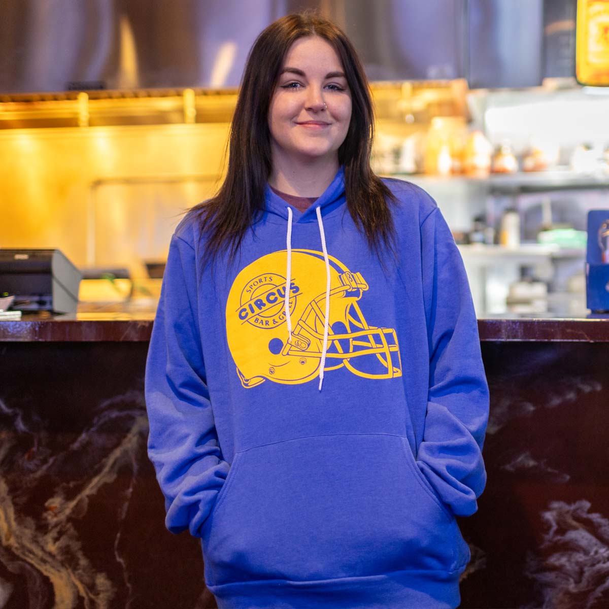 model wearing blue circus hoodie