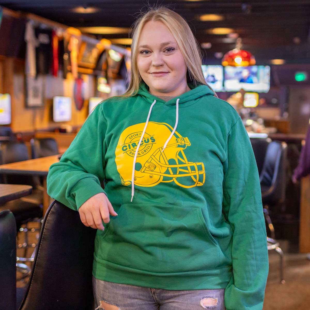 model wearing green circus hoodie